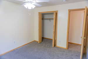Unfurnished bedroom featuring carpet floors, a ceiling fan, and a closet