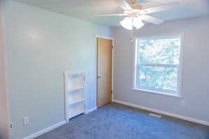 Unfurnished bedroom with carpet floors, ceiling fan, and a closet
