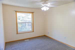 Spare room with carpet floors and ceiling fan