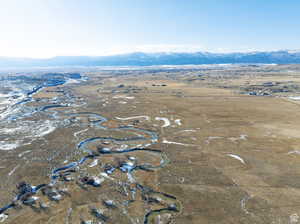 Aerial view of property's location with a mountainous background and rural landscape
