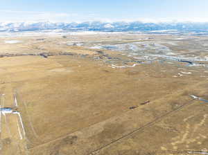 Aerial view of sparsely populated area featuring a mountainous background and a desert landscape