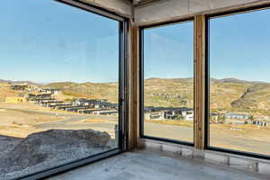 Doorway featuring a mountain view, a residential view, and healthy amount of natural light