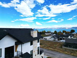 Exterior view of Bear Lake and mountain view, stone siding, roof with shingles, and a residential view.