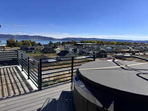 Wooden deck with a Bear Lake view, a mountain view, and a hot tub