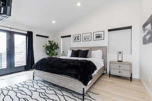 Primary Bedroom featuring lofted ceiling, french doors, access to outside, recessed lighting, and light wood finished floors