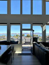 Living room featuring a Lake & mountain views, dark wood-style flooring, and a towering ceiling