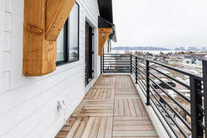 Deck off primary bedroom with lake and mountain views