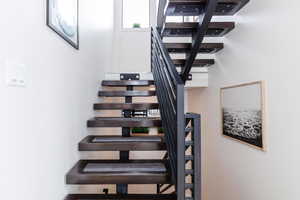 Staircase featuring a towering ceiling