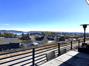 Balcony featuring a residential view and a water and mountain view