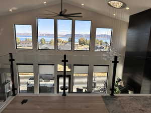 Dining room featuring lofted ceiling, a ceiling fan, wood finished floors, recessed lighting, and a water and mountain view