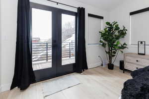 Entryway featuring wood finished floors and french doors
