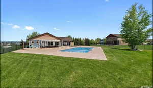 View of swimming pool with a fenced backyard and a patio area