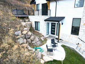 Entrance to property featuring stone siding
