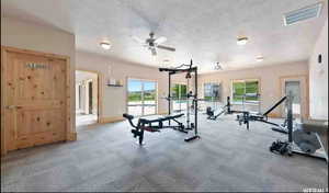 Exercise area with a textured ceiling and a ceiling fan