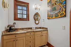 Bathroom with vanity and baseboards