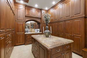 Kitchen featuring brown cabinets, a kitchen island, and recessed lighting