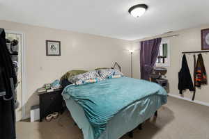 Bedroom featuring carpet flooring and a textured ceiling
