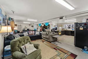 Living area featuring a textured ceiling and an office area