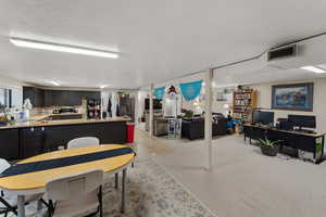 Dining space with a textured ceiling and an office area
