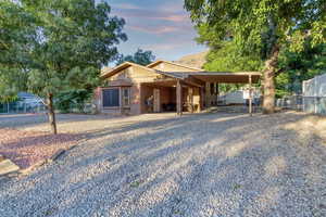 Ranch-style home with driveway and an attached carport