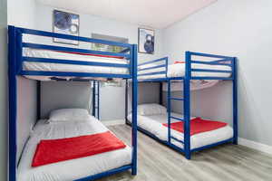 Bedroom featuring baseboards and wood finished floors