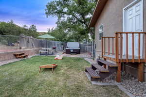 Fenced backyard with a hot tub