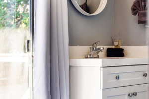 Bathroom with vanity and healthy amount of natural light
