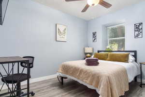 Bedroom featuring wood finished floors and a ceiling fan