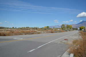 View of asphalt street featuring a mountain view