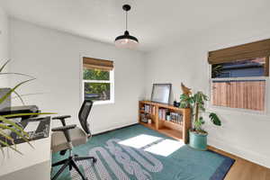 Upstairs Bedroom with baseboards and wood finished floors