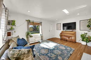 Living room featuring wood finished floors and recessed lighting
