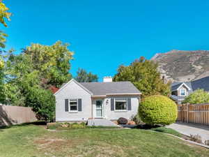 View of front of home featuring a fenced backyard and a chimney