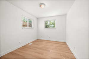 Unfurnished room featuring plenty of natural light and light wood-type flooring