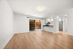 Unfurnished living room featuring light wood-type flooring and recessed lighting