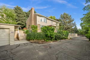 View of home's exterior featuring a chimney and brick siding
