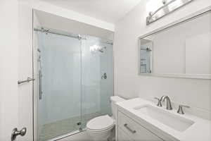 Bathroom with vanity and a stall shower
