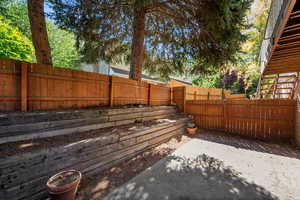 Fenced backyard with a patio area