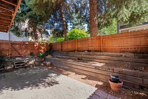 Fenced backyard featuring a patio