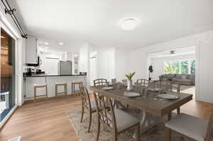 Dining room featuring light wood-type flooring, a ceiling fan, and recessed lighting