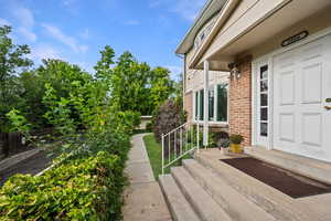 Doorway to property featuring brick siding