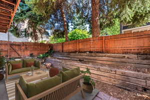 Fenced backyard featuring an outdoor living space and a patio area