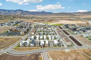 Aerial overview of property's location featuring nearby suburban area and mountains