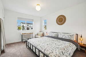 Bedroom featuring carpet floors and baseboards