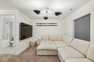 Living room with carpet floors and baseboards