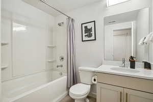 Bathroom with shower / bath combination with curtain and vanity
