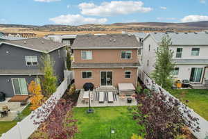 Rear view of property with a patio, a fenced backyard, a shingled roof, and a residential view