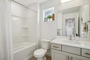 Bathroom with shower / tub combo with curtain, vanity, and tile patterned flooring