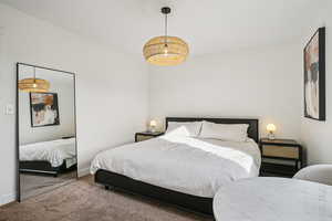 Carpeted bedroom with baseboards and a closet