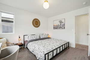 Carpeted bedroom with baseboards