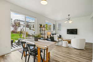 Dining room with light wood-style flooring and a chandelier